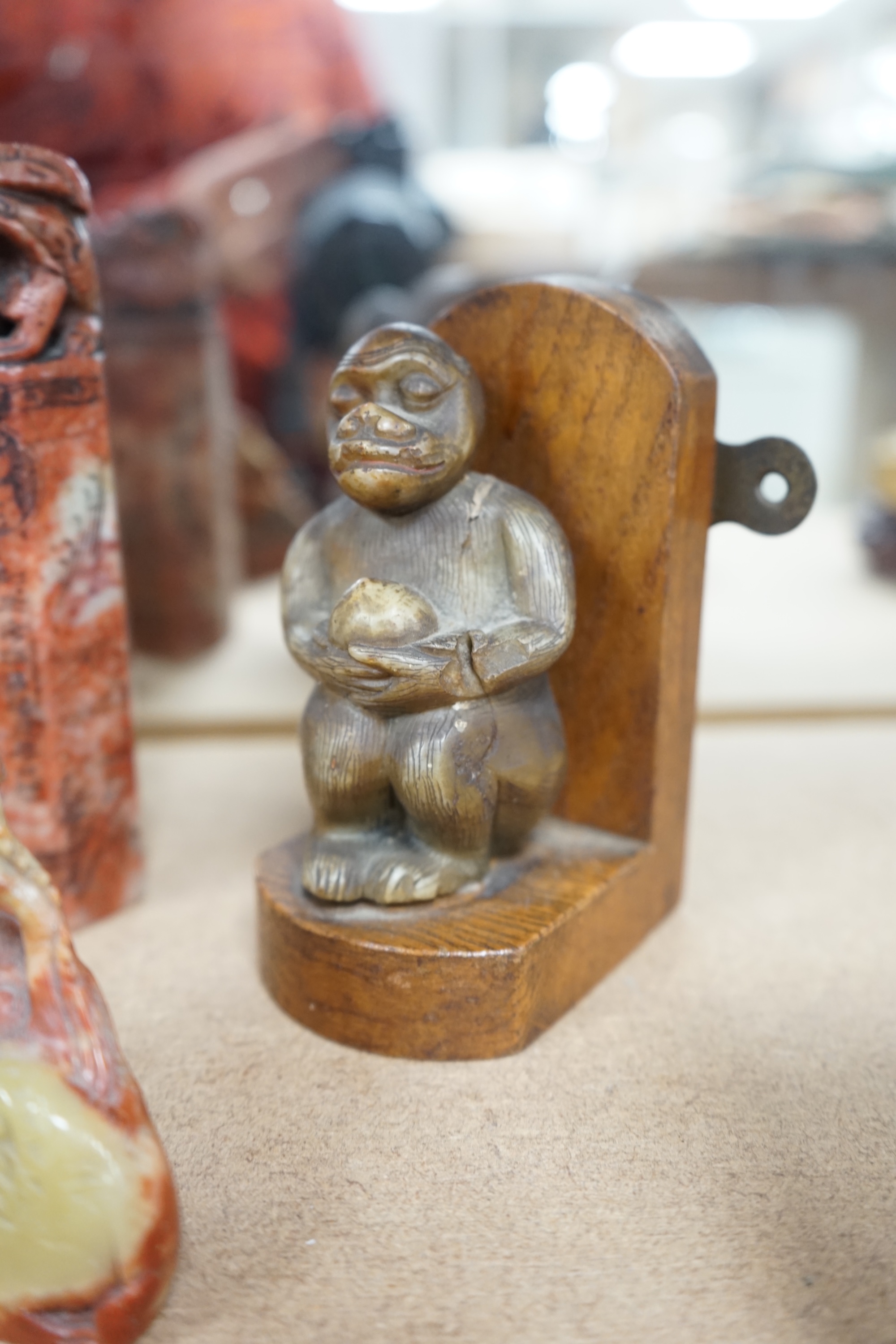 Five Chinese soapstone seals, a bronze figure of a Shou Lao, a pottery dog, a carved soapstone monkey and a Chinese famille rose bowl, 18th century, tallest 15cm high. Condition - poor to good